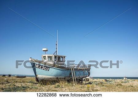 Boat on a shingle beach; Dungeness, Kent, England View Large Photo Image Stock Photo - Boat on a shingle beach; Dungeness, Kent, England. Fotosearch