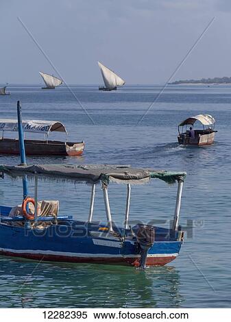 Stock Photography - Boats and dhows in the harbour; Zanzibar, Tanzania. Fotosearch