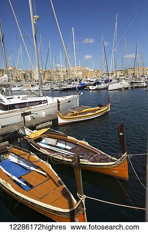 Stock Photograph - Boats in a harbour; Senglea, Malta Island, Malta. Fotosearch