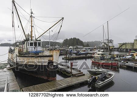 Stock Photograph - Boats in fog by dock; Tofino, Vancouver Island, British Columbia, Canada. Fotosearch