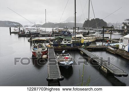 Stock Photograph - Boats in fog by dock; Tofino, Vancouver Island, British Columbia, Canada. Fotosearch