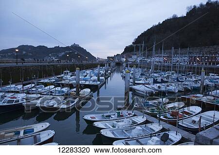 Boats in the harbour at dusk; San Sebastian, Spain View Large Photo Image Stock Image - Boats in the harbour at dusk; San Sebastian, Spain. Fotosearch