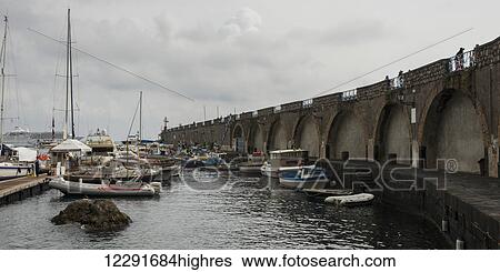 Boats in the harbour under a cloudy sky along the Amalfi coast; Amalfi, Campania, Italy View Large Photo Image Stock Photograph - Boats in the harbour under a cloudy sky along the Amalfi coast; Amalfi, Campania, Italy. Fotosearch