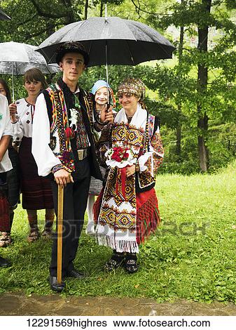 Stock Photograph - Bride and groom accompanied by relatives and friends going to the church, Hutsuls are a small mountain peoples who inhabited Carpathians, wearing traditional folk costumes only during the holidays or weddings; Kryvorivnia, Verkhovyna district,.... Fotosearch