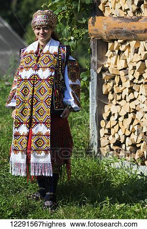 Bride in national dress posing in the yard, Hutsuls is a small mountain peoples who inhabited Carpathians and their traditional folk costumes can be seen only during the holidays or weddings; Kryvorivnia, Verkhovyna district, Ivano-Frankivsk region,... View Large Photo Image Stock Photograph - Bride in national dress posing in the yard, Hutsuls is a small mountain peoples who inhabited Carpathians and their traditional folk costumes can be seen only during the holidays or weddings; Kryvorivnia, Verkhovyna district, Ivano-Frankivsk region,.... Fotosearch