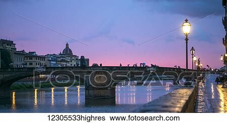 Stock Photograph - Bridges crossing the Arno River at dusk; Florence, Toscana, Italy. Fotosearch