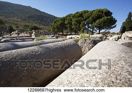 Stock Photograph - Broken and fallen columns at a ruins site; Ephesus, Izmir, Turkey. Fotosearch
