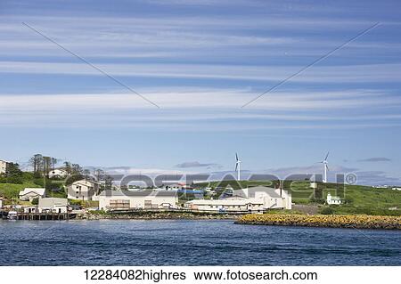 Stock Photograph - Buildings and warehouses at the waterfront in Sand Point Harbor, Sand Point, Southwestern Alaska, USA, Summer. Fotosearch