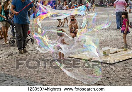 Busker making bubbles in Plaza mayor; Madrid, Spain View Large Photo Image Stock Photograph - Busker making bubbles in Plaza mayor; Madrid, Spain. Fotosearch