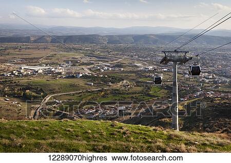 Stock Photograph - Cable car traveling over the site of an ancient city; Pergamum, Turkey. Fotosearch