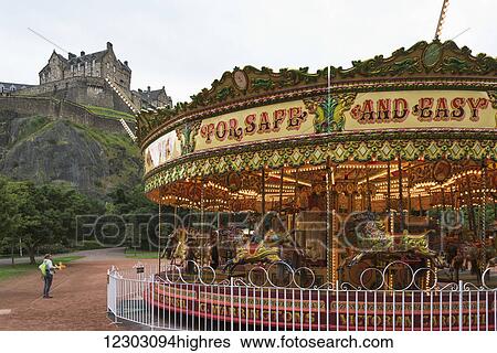 Stock Photograph - Carousel in Princes Street Gardens with a view of Edinburgh Castle; Edinburgh, Scotland. Fotosearch