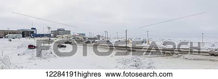 Stock Photograph - Cars and trucks drive on snow covered road in downtown Barrow, North Slope, Arctic Alaska, USA, Winter. Fotosearch