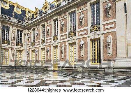 Stock Photograph - Chateau de Versailles, entrance courtyard with black and white tiled floor; Versailles, France. Fotosearch