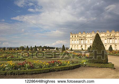 Stock Photograph - Chateau de Versailles, gardens with building in the background; Versailles, France. Fotosearch