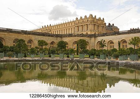 Stock Photograph - Chateau de Versailles, reflects in the pond of l'Orangerie; Versailles, France. Fotosearch