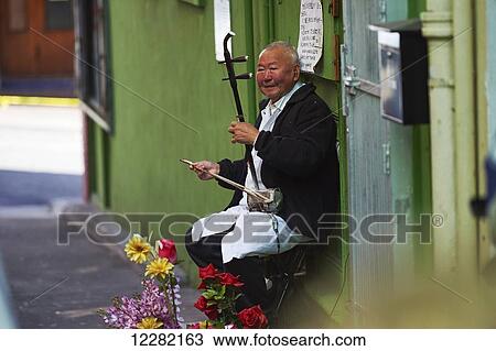 Chinese man playing Erhu in Chinatown; San Francisco, California, United States of Ameirca View Large Photo Image Stock Image - Chinese man playing Erhu in Chinatown; San Francisco, California, United States of Ameirca. Fotosearch