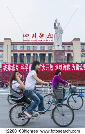 Chinese people riding bicycles on the street while Mao Zedong statue raises his hand; Chengdu, Sichuan province, China View Large Photo Image Stock Photograph - Chinese people riding bicycles on the street while Mao Zedong statue raises his hand; Chengdu, Sichuan province, China. Fotosearch