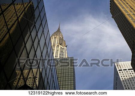 Chrysler Building and other skyscrapers against a blue sky with cloud; New York City, New York, United States of America View Large Photo Image Stock Photograph - Chrysler Building and other skyscrapers against a blue sky with cloud; New York City, New York, United States of America. Fotosearch