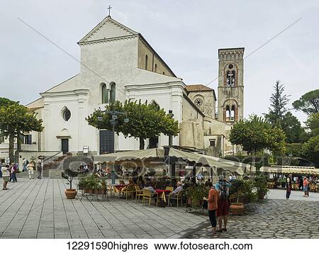 Stock Photograph - Church building with pedestrians and an outdoor seating area; Ravello, Italy. Fotosearch