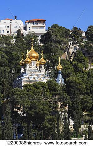 Stock Photograph - Church with gold onion domes and crosses on a hillside; Jerusalem, Israel. Fotosearch