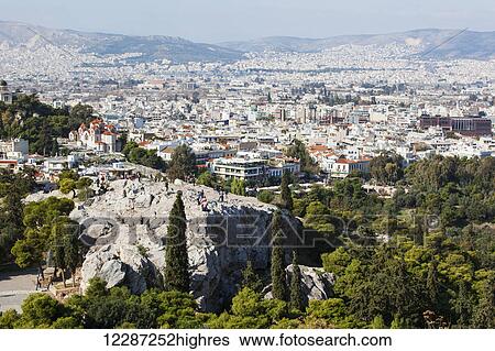 Stock Photograph - Cityscape of Athens and tourists on Areopagus; Athens, Greece. Fotosearch
