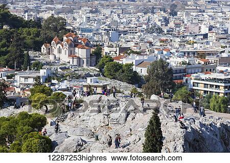 Stock Photograph - Cityscape of Athens and tourists on Areopagus; Athens, Greece. Fotosearch
