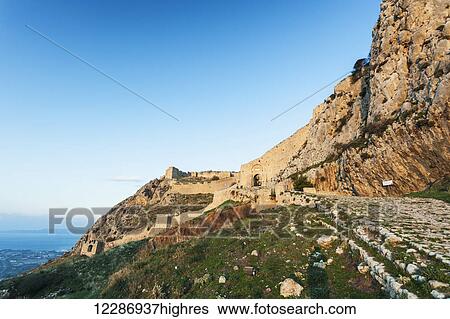 Stock Photograph - Cliff and stone wall overlooking the Gulf of Corinth; Corinth, Greece. Fotosearch
