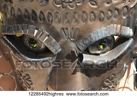 Stock Photograph - Close up detail of a metal sculpture of a face; San Miguel de Allende, Guanajuato, Mexico. Fotosearch