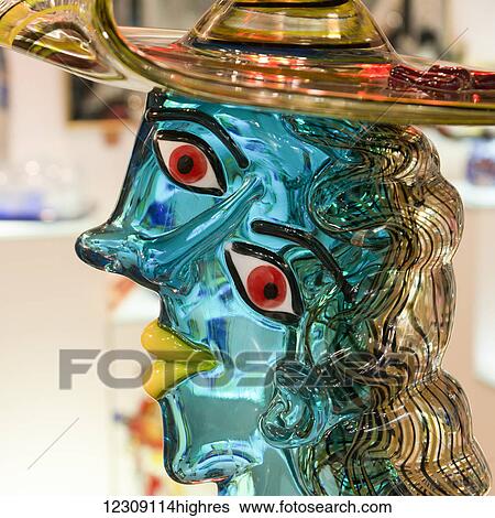Close up of a colourful glass figure with a uniquely shaped face; Venice, Italy View Large Photo Image Stock Photograph - Close up of a colourful glass figure with a uniquely shaped face; Venice, Italy. Fotosearch