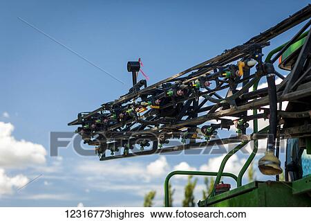 Close up of farm equipment against blue sky and cloud; Herschel, Saskatchewan, Canada View Large Photo Image Stock Photograph - Close up of farm equipment against blue sky and cloud; Herschel, Saskatchewan, Canada. Fotosearch