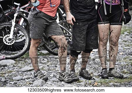 Stock Photograph - Close up of muddy mountain bikers after a long ride on the Resurrection Pass Trail, Chugach National Forest, Kenai Peninsula, Southcentral Alaska. Fotosearch