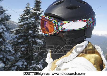 Stock Photograph - Close-up of skier in goggles and helmet; Whistler, British Columbia, Canada. Fotosearch