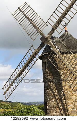Stock Image - Close up of stone windmill with wooden blades; Plouezec, Brittany, France. Fotosearch