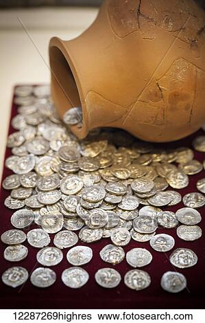 Stock Photograph - Coins and pottery on display at an archaeological museum; Pella, Macedonia, Greece. Fotosearch