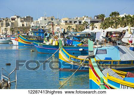 Stock Photograph - Colourful fishing boats; Marsaxlokk, Malta. Fotosearch