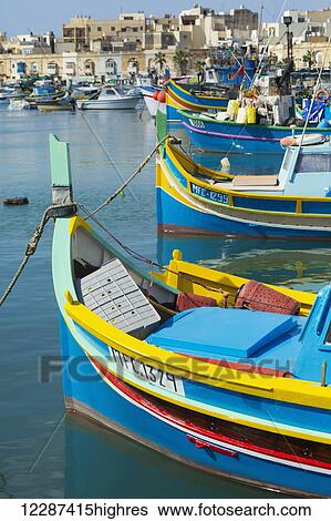 Stock Photograph - Colourful fishing boats; Marsaxlokk, Malta. Fotosearch