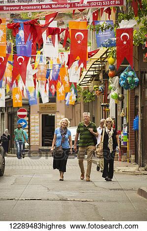 Stock Photograph - Colourful flags above the street on Balat and Fener walk; Istanbul, Turkey. Fotosearch