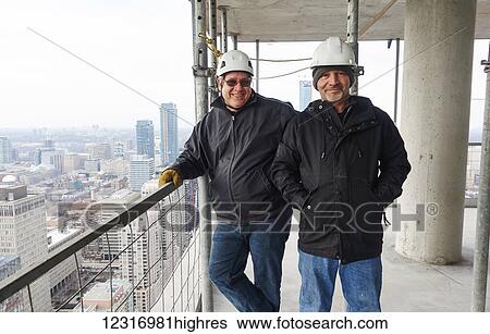 Construction workers with a view from the 44th floor of a new building on Yonge and College Streets; Toronto, Ontario, Canada View Large Photo Image Stock Photograph - Construction workers with a view from the 44th floor of a new building on Yonge and College Streets; Toronto, Ontario, Canada. Fotosearch