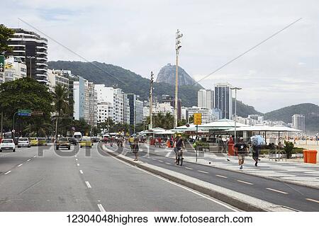 Stock Photograph - Copacabana Beach and Avenue Atlantica, with Sugarloaf Mountain in distance; Rio de Janeiro, Brazil. Fotosearch