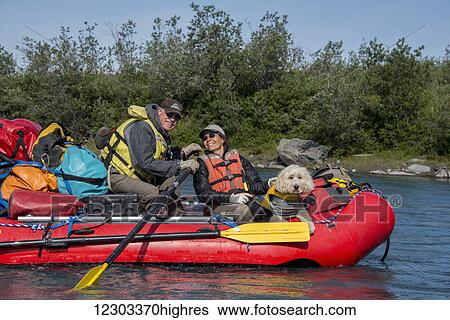 Couple and their Golden Doodle sitting in a raft in the sunshine along the Marsh Fork of the Canning River in the Arctic National Wildlife Refuge, Summer, Alaska View Large Photo Image Stock Photograph - Couple and their Golden Doodle sitting in a raft in the sunshine along the Marsh Fork of the Canning River in the Arctic National Wildlife Refuge, Summer, Alaska. Fotosearch
