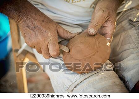 Stock Photograph - Craftsman making leather masks, near Tharros; Sardinia, Italy. Fotosearch