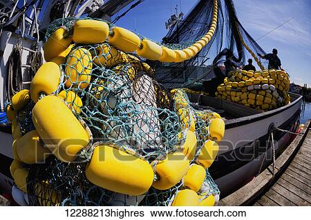 Crew members stack corks aboard commercial fishing seiner, Kodiak, Alaska View Large Photo Image Stock Photograph - Crew members stack corks aboard commercial fishing seiner, Kodiak, Alaska. Fotosearch