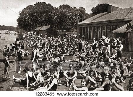 Stock Photography - Crowds of people at the Lansbury Lido at the Serpentine in Hyde Park, London, England in 1930. From The Story of 25 Eventful Years in Pictures published 1935. Fotosearch