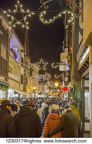 Stock Photograph - Crowds visit the Christmas market in the heart of the old town; Altenahr, Nordrhein Westfalen, Germany. Fotosearch