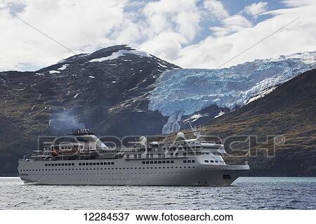 Stock Photo - Cruise ship in front of Romanche Glacier along Beagle Channel in Alberto de Agostini National Park; Magallanes region, Chile. Fotosearch