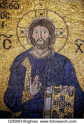 Stock Photograph - Detail of the Empress Zoe mosaic, Christ is clad in the dark blue robe (as is the custom in Byzantine art), is seated against a golden background, giving His blessing with the right hand and holding the Bible in His left hand; Istanbul, Turkey. Fotosearch