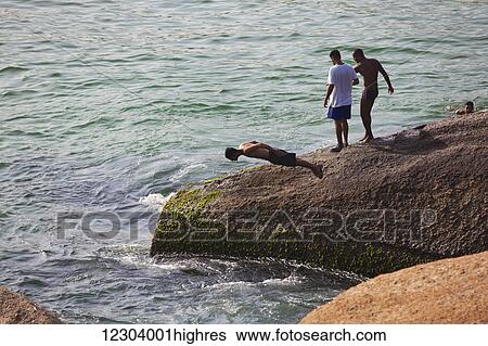Diving into the sea off rocks along the coast; Rio de Janeiro, Brazil View Large Photo Image Stock Photograph - Diving into the sea off rocks along the coast; Rio de Janeiro, Brazil. Fotosearch
