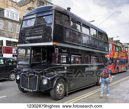 Stock Photograph - Double decker tour buses on the street; Edinburgh, Scotland. Fotosearch