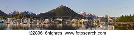 Downtown Sitka and the O'Connell bridge on a clear summer evening, Sitka harbour and docked fishing boats in the foreground, the Sisters Mountains with snow on the peaks in the background; Sitka, Alaska, United States of America View Large Photo Image Stock Photograph - Downtown Sitka and the O'Connell bridge on a clear summer evening, Sitka harbour and docked fishing boats in the foreground, the Sisters Mountains with snow on the peaks in the background; Sitka, Alaska, United States of America. Fotosearch