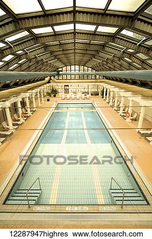 Stock Photograph - Drained indoor swimming pool with sun loungers; Ankara, Turkey. Fotosearch